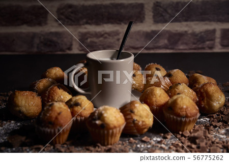 group of muffins next to a cup of milk group of muffins next to a cup of milk 56775262