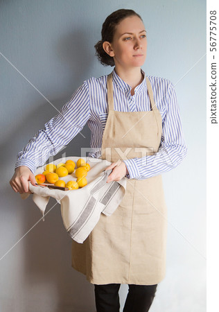 Young woman with a tray of peaches and apricots 56775708
