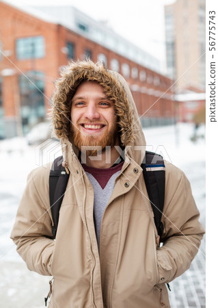 A bearded young man walks on winter street A bearded young man walks on winter street 56775743