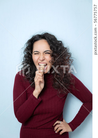 Girl eats a chocolate and shows emotions Girl eats a chocolate and shows emotions 56775757