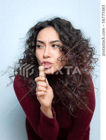Girl eats a chocolate and shows emotions Girl eats a chocolate and shows emotions 56775865