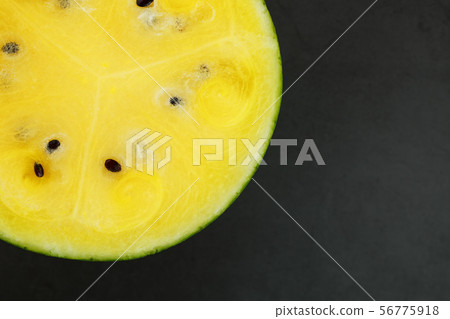 Half of tasty and ripe yellow watermelon on a 56775918
