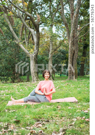 Young woman doing yoga outdoors Young woman doing yoga outdoors 56776343