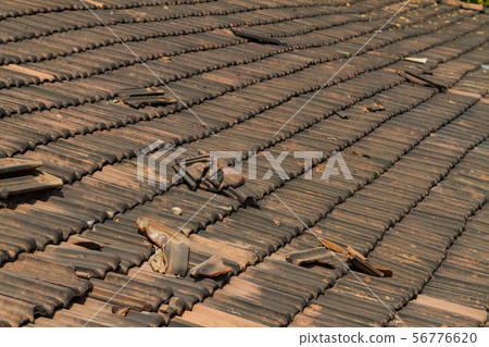 Broken old terracotta tile on a roof 56776620