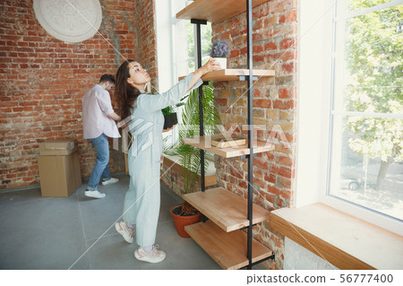 Young couple moved to a new house or apartment 56777400
