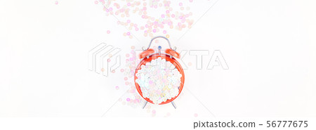 Pearl pastel confetti sparkles and red alarm clock Pearl pastel confetti sparkles and red alarm clock 56777675