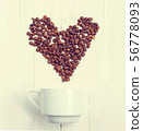 Grain of coffee in the form of a heart over a cup. 56778093