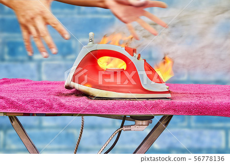The iron for clothes is overheated and ignited. The iron for clothes is overheated and ignited. 56778136
