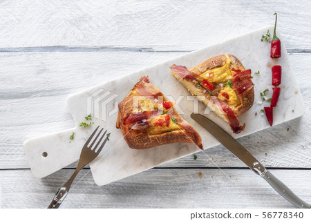 Breakfast with  baked omelet and bacon in bread 56778340
