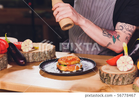 Chef making healthy vegetarian salmon burgers outdoor on open kitchen, odprta kuhna, international Chef making healthy vegetarian salmon burgers outdoor on open kitchen, odprta kuhna, international 56778467