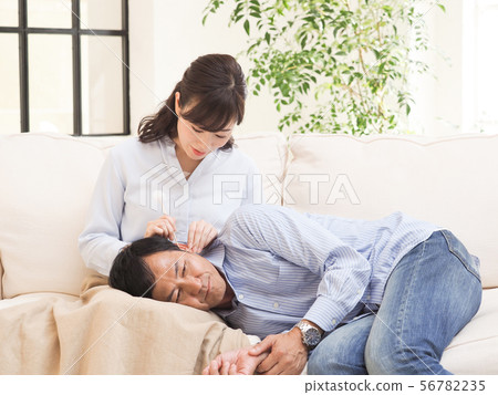 Couples doing ear cleaning with knee pillow 56782235