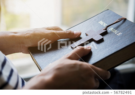 Christian woman praying on holy bible. Hands Christian woman praying on holy bible. Hands 56782491