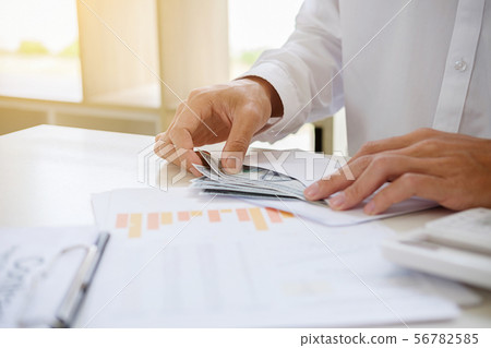 Businessman giving money while making deal to Businessman giving money while making deal to 56782585