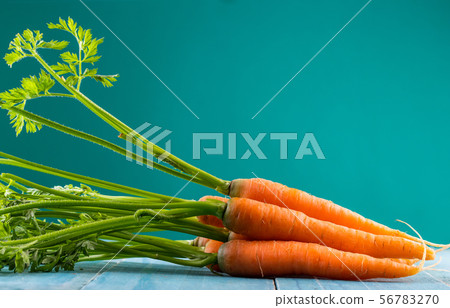 Fresh and sweet carrot on a grey wooden table 56783270