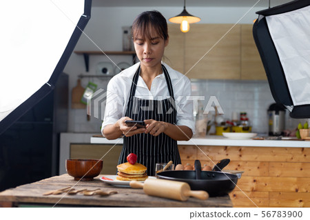 photographer food , asian women is taking pictures 56783900