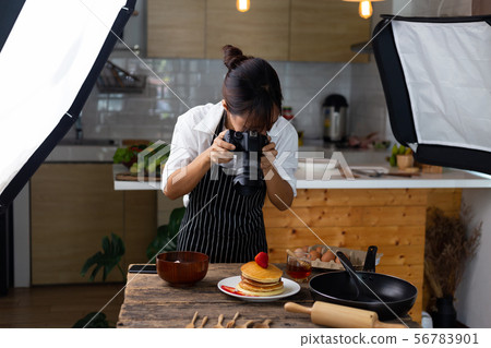 photographer food , asian women is taking pictures 56783901