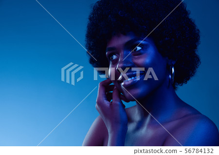 Portrait of female high fashion model in neon light 56784132