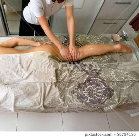 Young woman at massage therapy in spa centre Young woman at massage therapy in spa centre 56784156