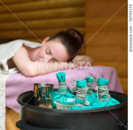 Beauty and health. Thai massage with salt bags Beauty and health. Thai massage with salt bags 56784159