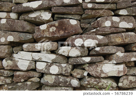 Old stone wall with white spots Old stone wall with white spots 56786239