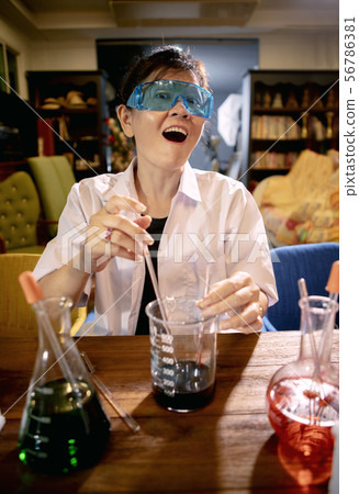funny female scientist in chemical laboratory 56786381