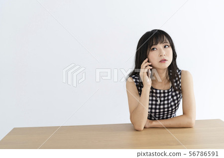 Woman using a smartphone Woman using a smartphone 56786591