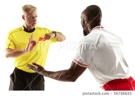 Football referee showing a red card to a displeased player isolated on white background 56786683