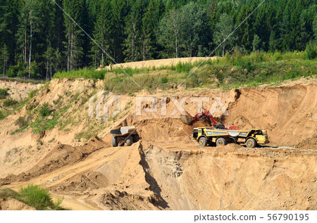 Excavator loading sand in dump truck in quarry 56790195
