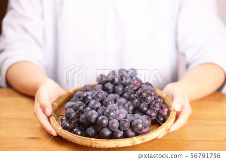 Woman with grape grapes Woman with grape grapes 56791756
