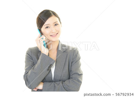 A woman talking on a smartphone 56792934