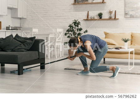 Housewife tiding up cozy apartment stock photo Housewife tiding up cozy apartment stock photo 56796262