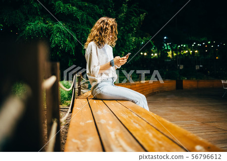 Unrecognizable young woman wearing white shirt Unrecognizable young woman wearing white shirt 56796612