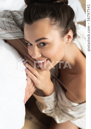 Pretty lady resting her head on hands and smiling 56797541
