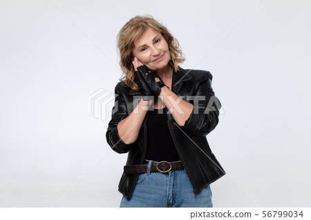 Senior smiling woman in leather jacket. Studio shot Senior smiling woman in leather jacket. Studio shot 56799034