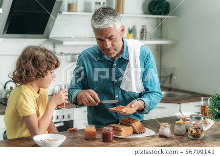 Happy father and little kid making breakfast Happy father and little kid making breakfast 56799141