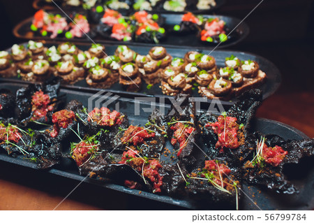 crackers with cream cheese and black caviar, horizontal. 56799784