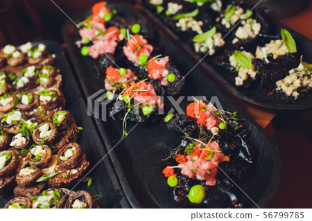 crackers with cream cheese and black caviar, horizontal. crackers with cream cheese and black caviar, horizontal. 56799785