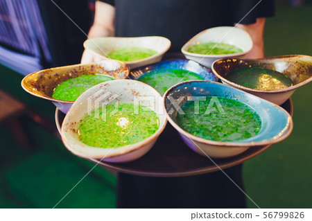 Waiter with a soup during a party. 56799826