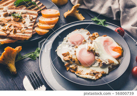 Fried eggs and toasts with fried chanterelles. Fried eggs and toasts with fried chanterelles. 56800739