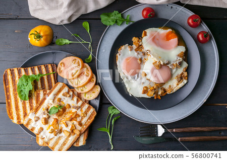 Fried eggs with mushrooms and toasts Fried eggs with mushrooms and toasts 56800741