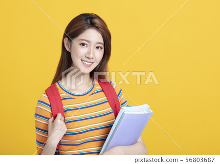 Portrait of beautiful asian young student holding Portrait of beautiful asian young student holding 56803687
