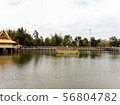 fountain in the middle of a pond in a Thai temple 56804782