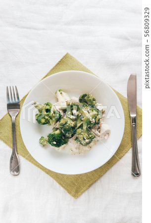 baked broccoli with chicken on a white plate. Top baked broccoli with chicken on a white plate. Top 56809329