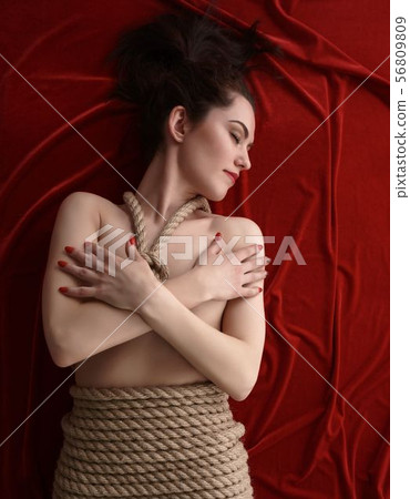 Shibari. Top view of pretty woman tied with rope 56809809