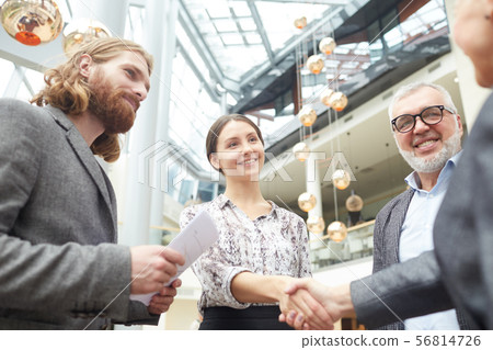 Business People Shaking Hands in Lobby Business People Shaking Hands in Lobby 56814726