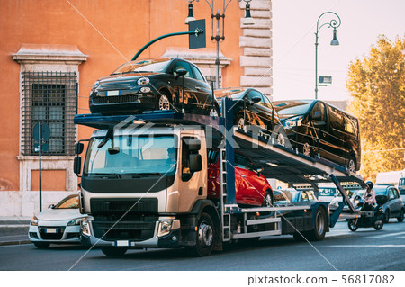 Auto-transport Carrying New Fiat Cars In European City Street. Auto Transport Broker Or Car 56817082