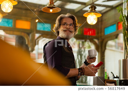 Cheerful man drinking coffee waiting for a friend. 56817649