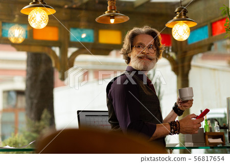 Smiling man turning back looking at waiter. Smiling man turning back looking at waiter. 56817654