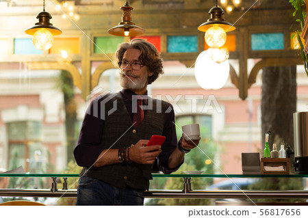 Man noticing one of his friends in the cafe. Man noticing one of his friends in the cafe. 56817656