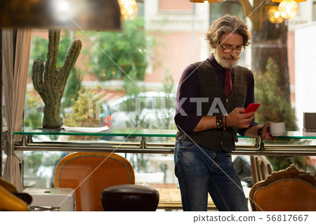 Concentrated man reading news on his smartphone. 56817667